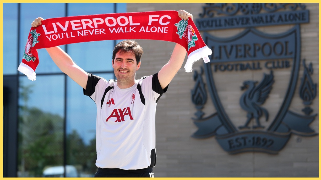 Andoni Iraola holds up a Liverpool scarf at the AXA Training Centre