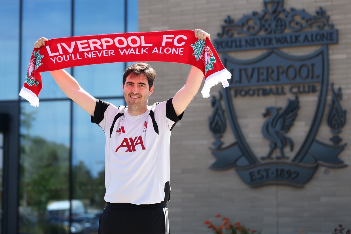Andoni Iraola holds up a Liverpool scarf at the AXA Training Centre