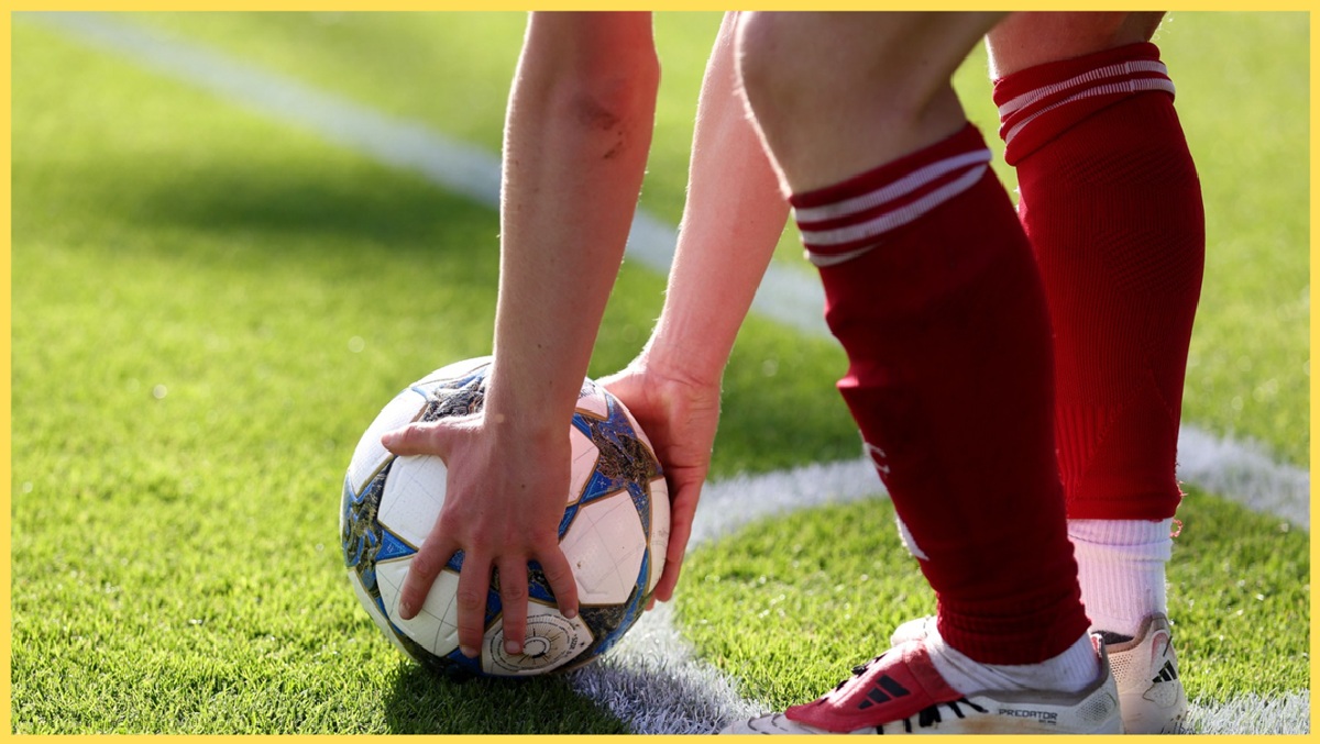A Liverpool academy player prepares to take a corner kick