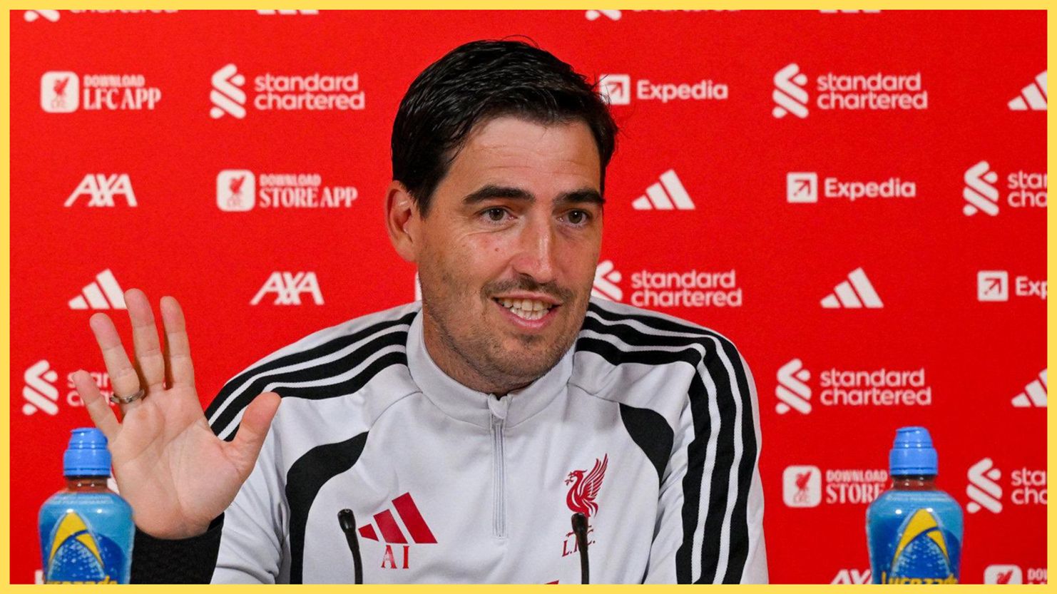 Liverpool manager Andoni Iraola waves his hand during press conference.