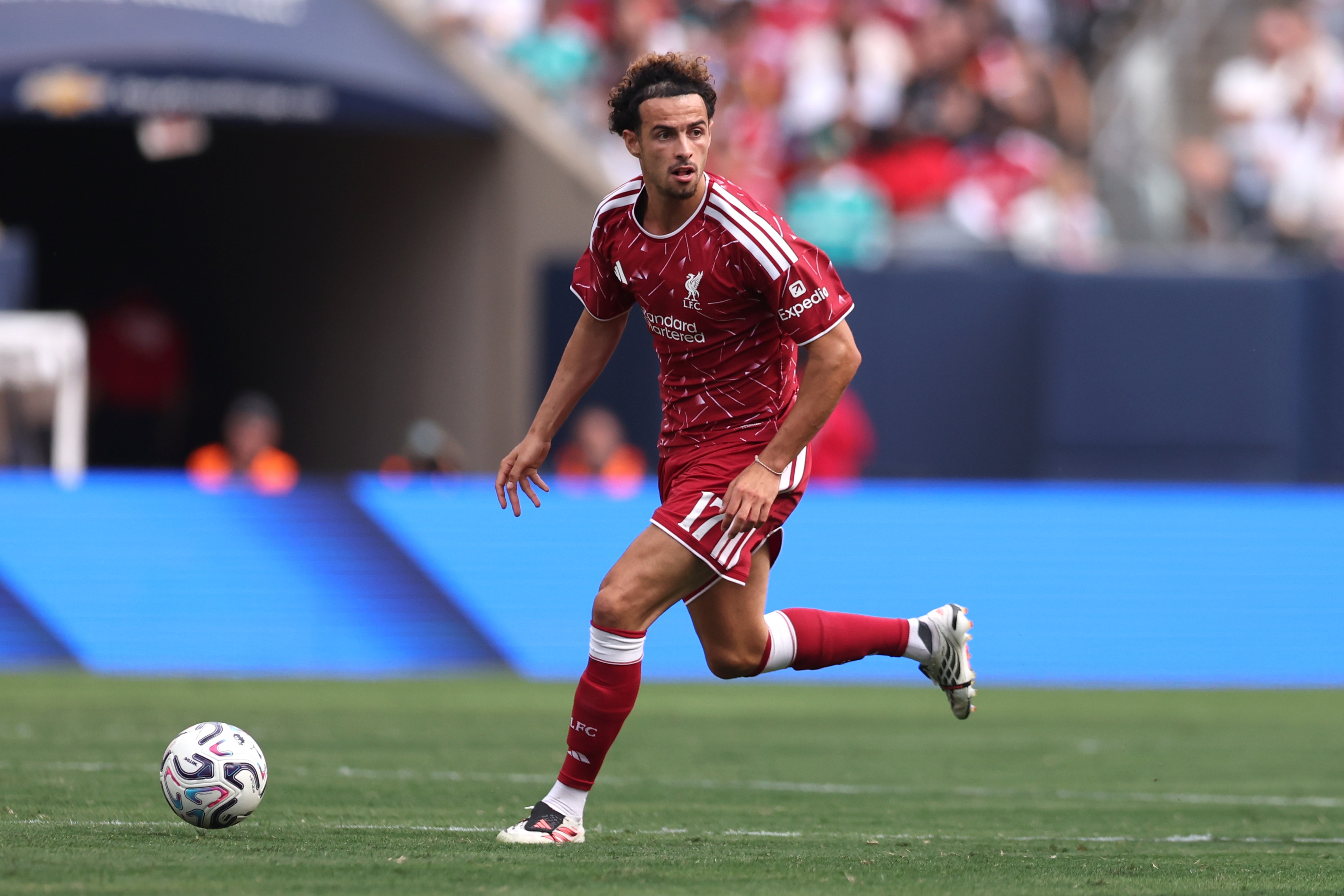 Curtis Jones dribbles with the ball during Liverpool game.