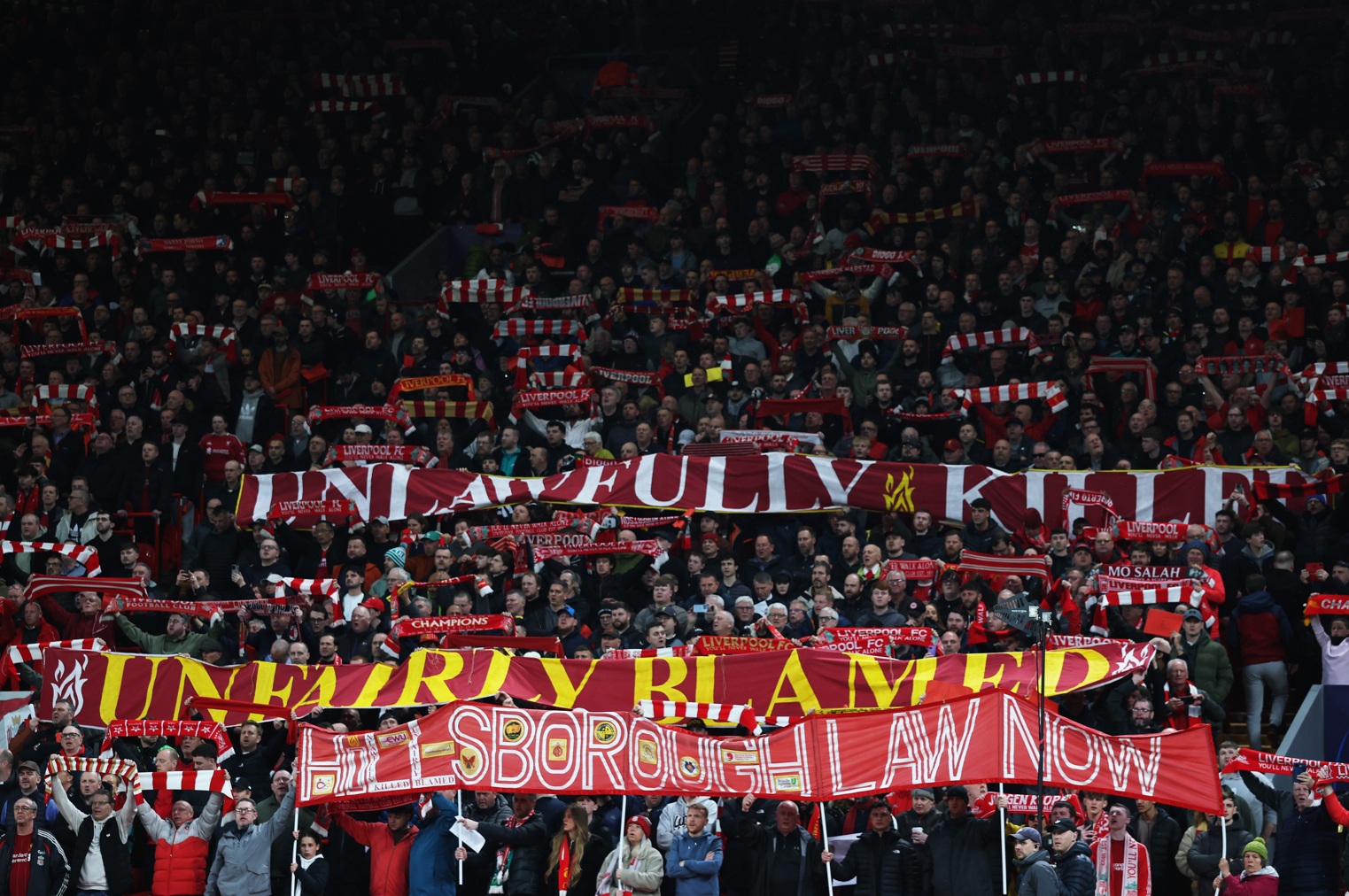 Liverpool fans display banners calling for the implementation of Hillsborough Law