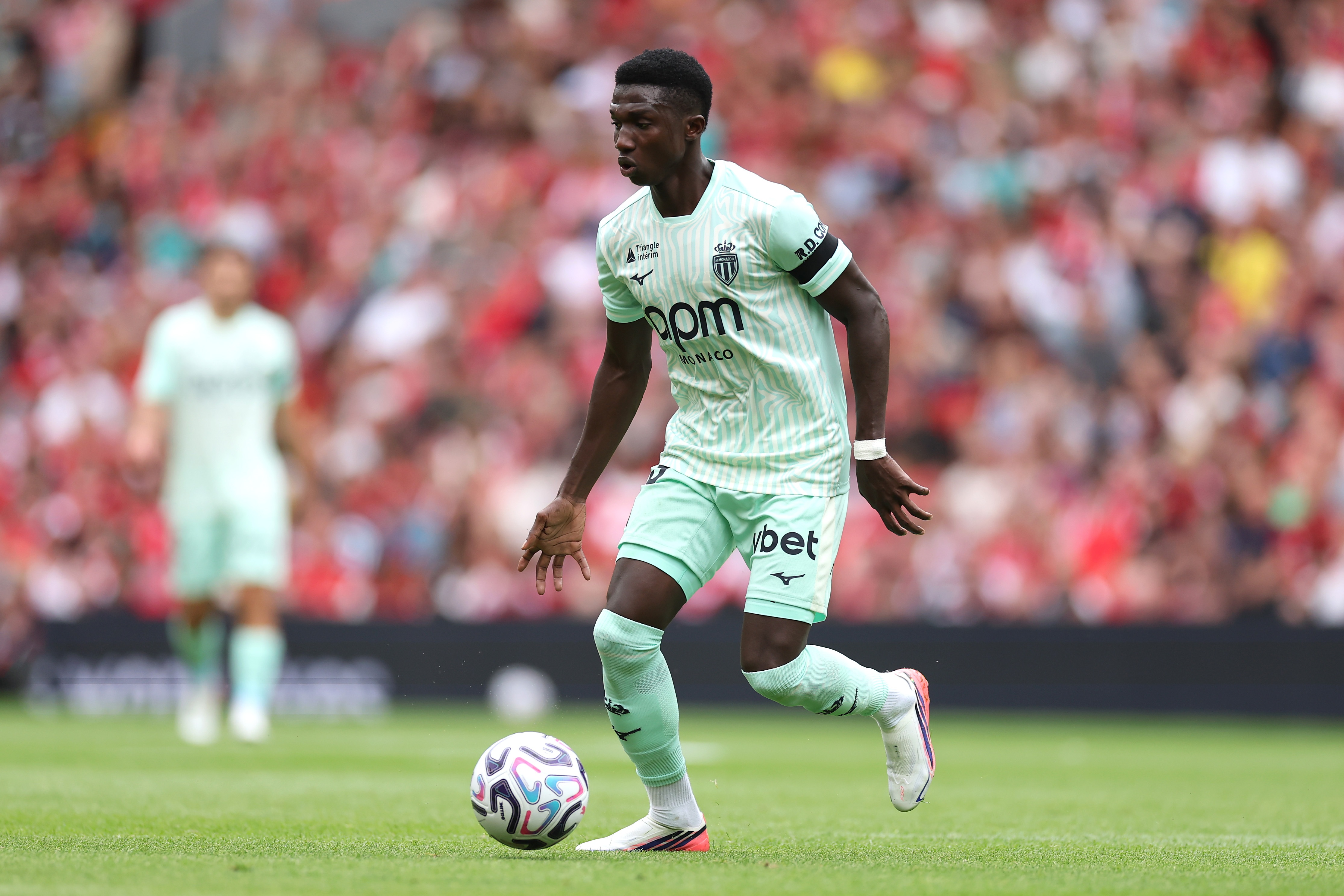 Liverpool transfer target Lamine Camara dribbles the ball.