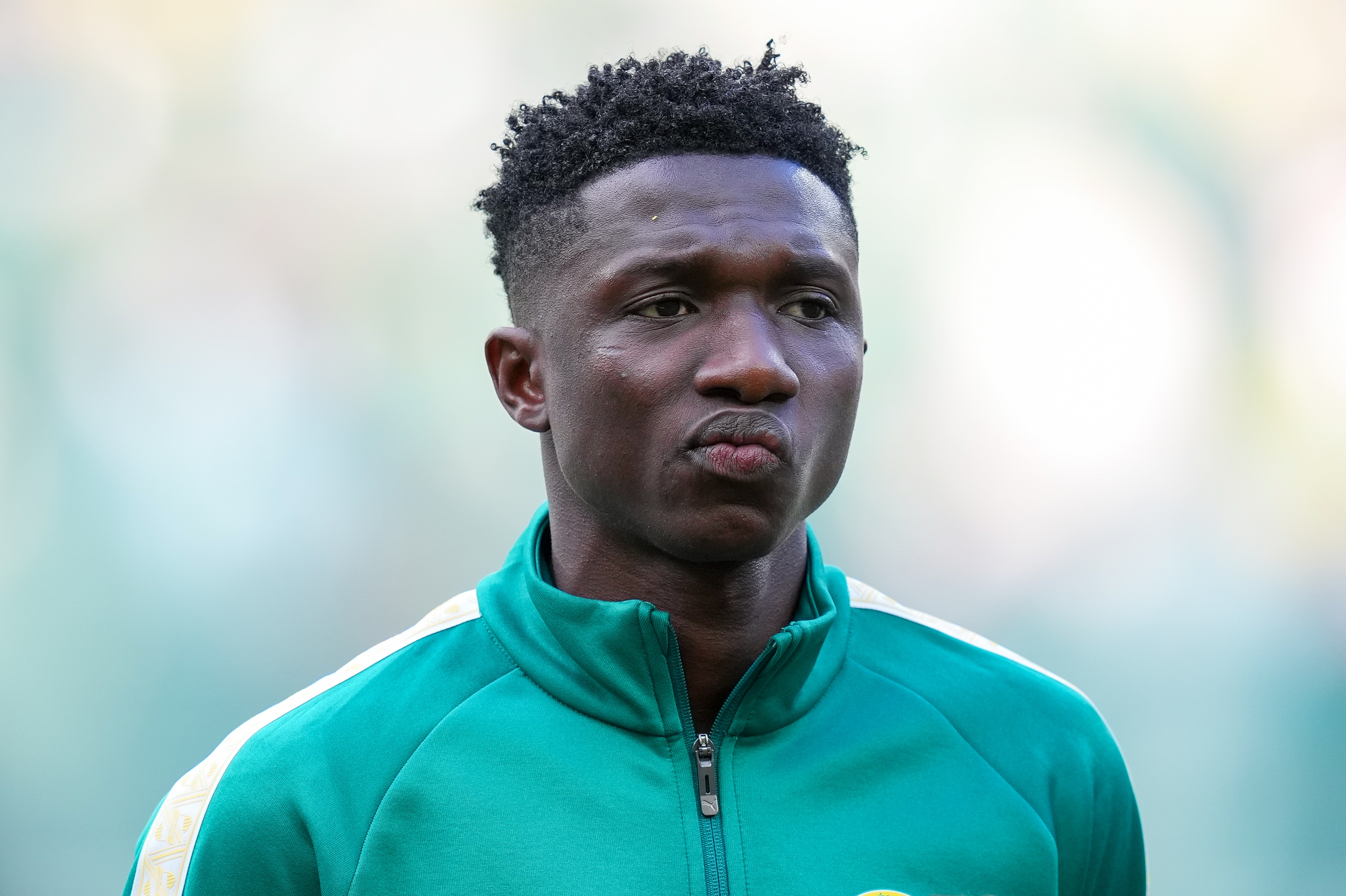 Liverpool transfer target Lamine Camara chews his cheek during Senegal game.