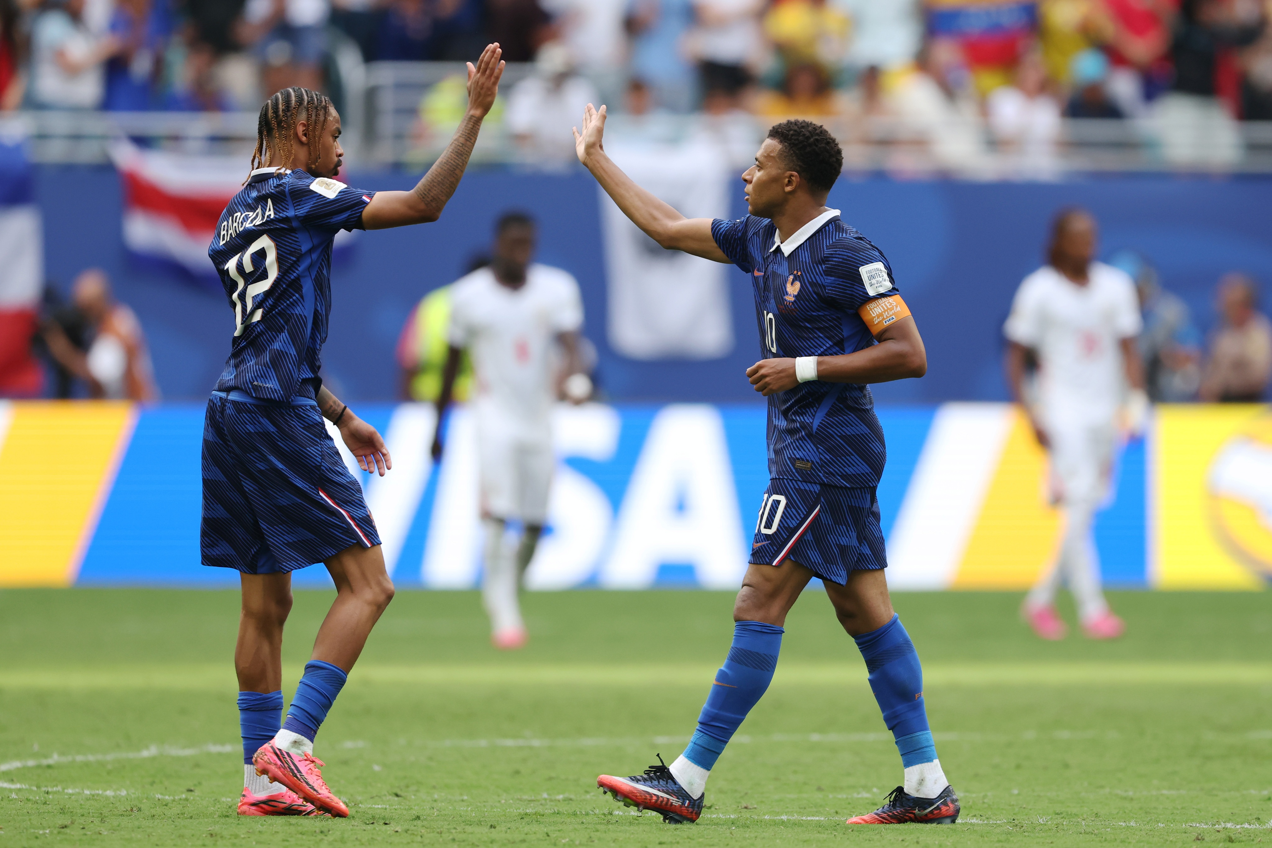 Liverpool transfer target Bradley Barcola high fives France teammate Kylian Mbappe.