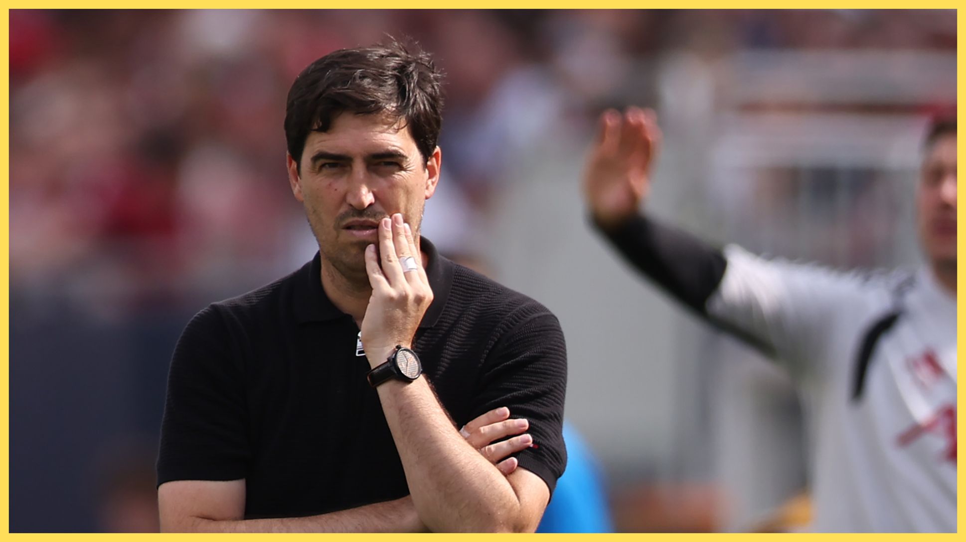 Liverpool manager Andoni Iraola anxiously rubs his face.
