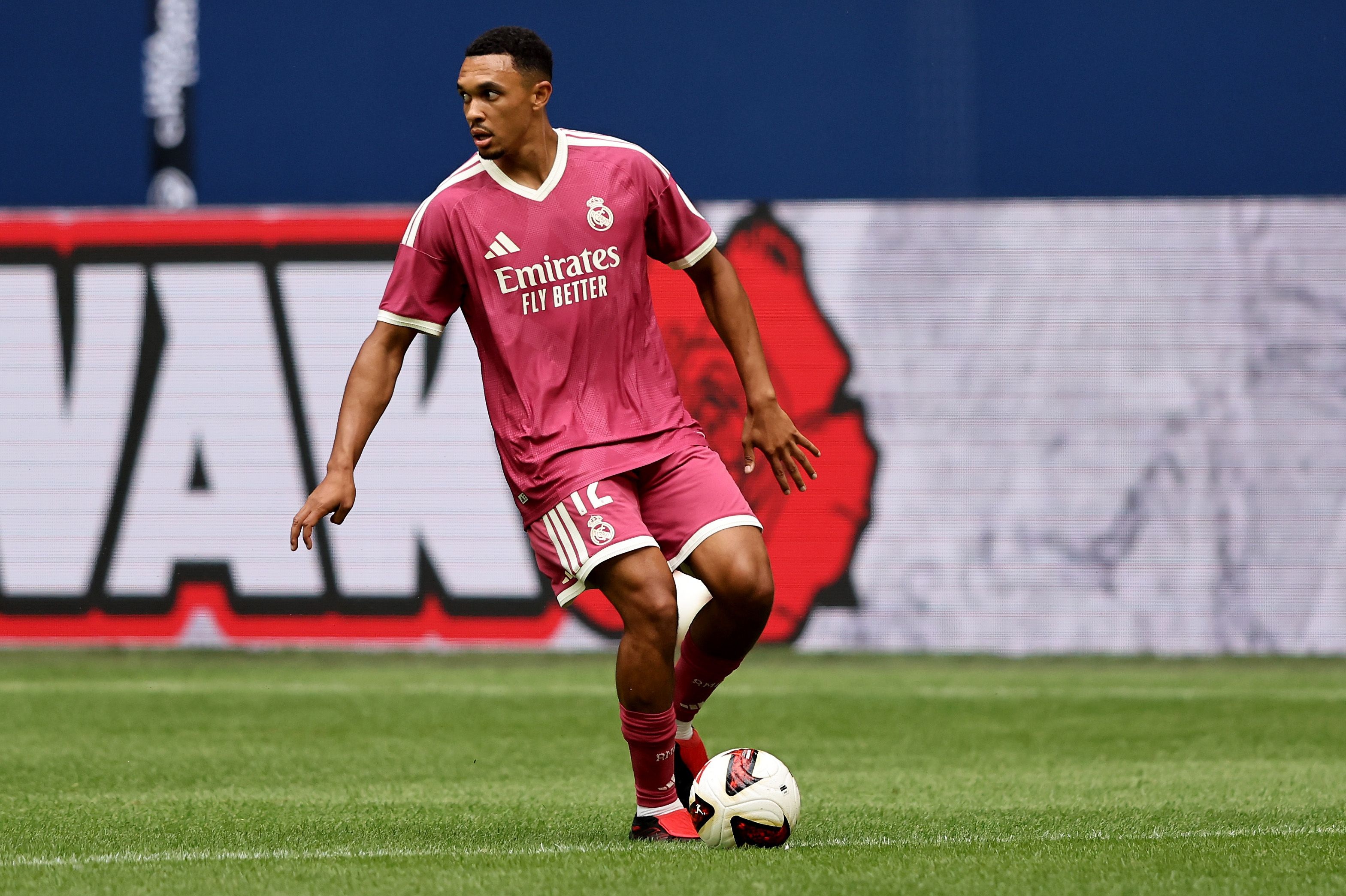 Trent Alexander-Arnold dribbles with the ball during Real Madrid game.