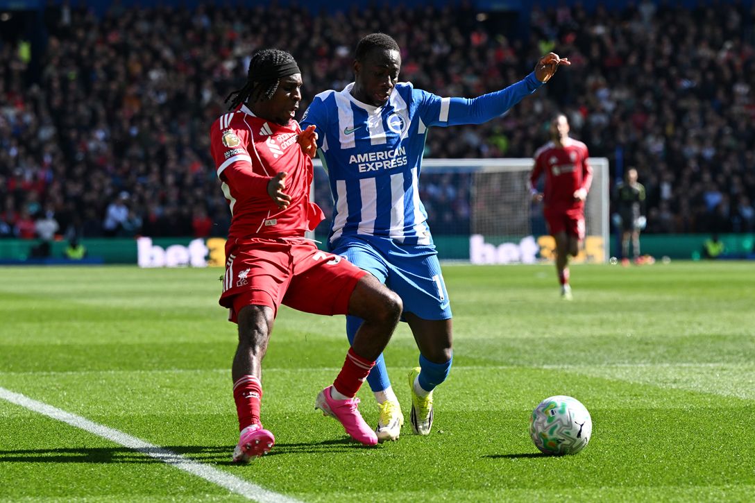 Yankuba Minteh battles Liverpool fullback Jeremie Frimpong for possession of the ball.