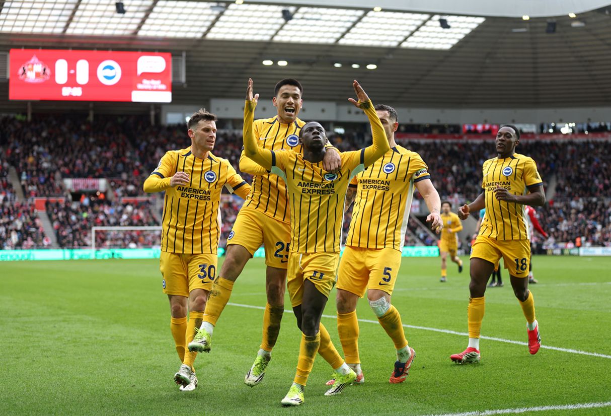 Liverpool transfer target Yankuba Minteh celebrates with Brighton teammates.