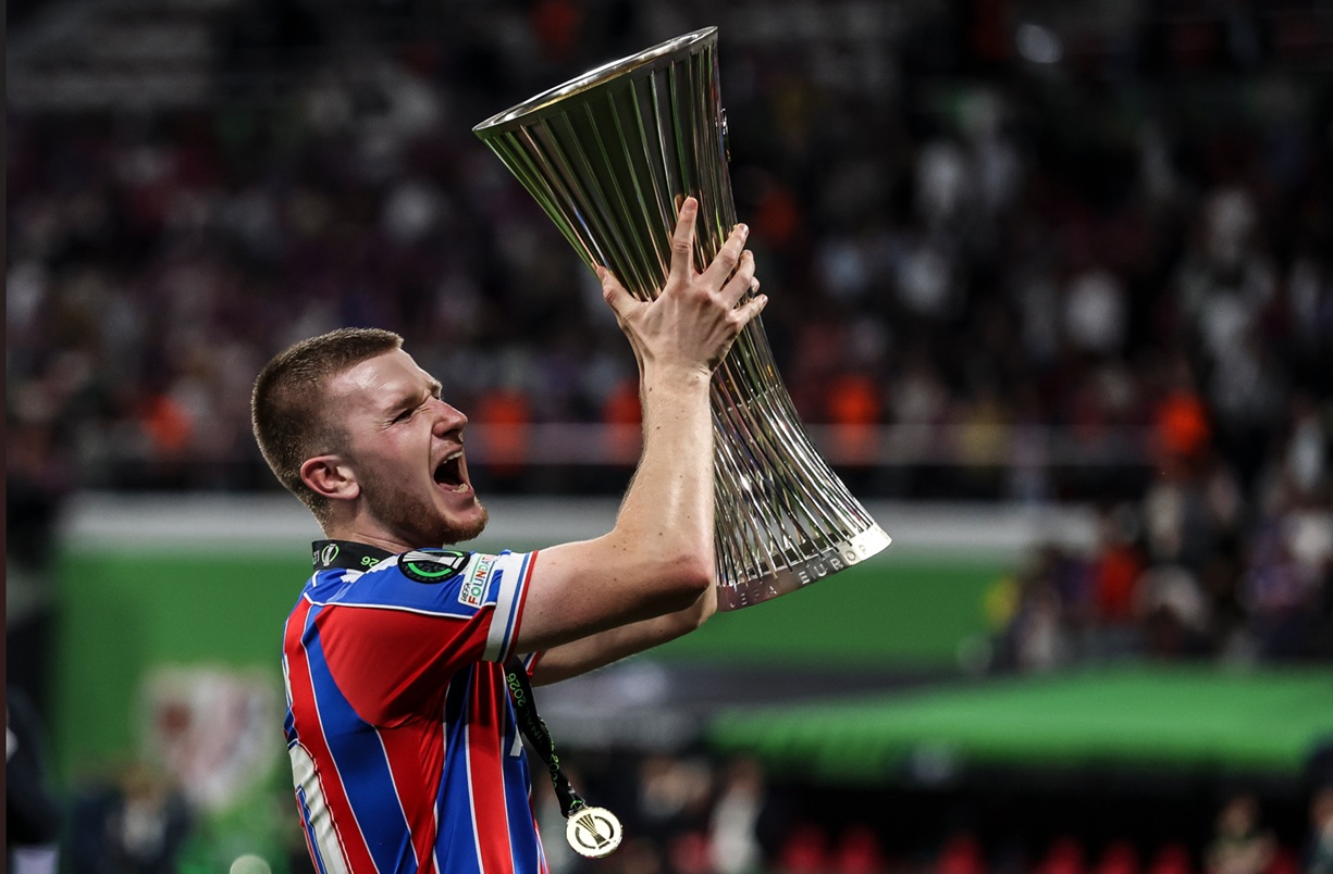 Adam Wharton raises the Conference League trophy