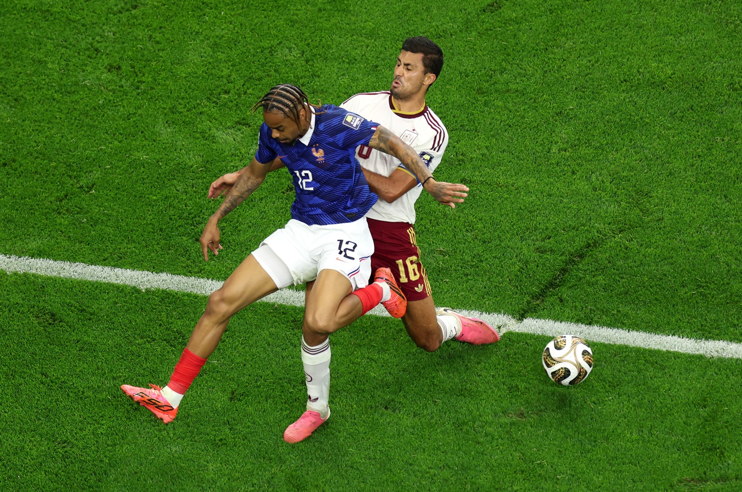 Bradley Barcola is put under pressure by Rodri