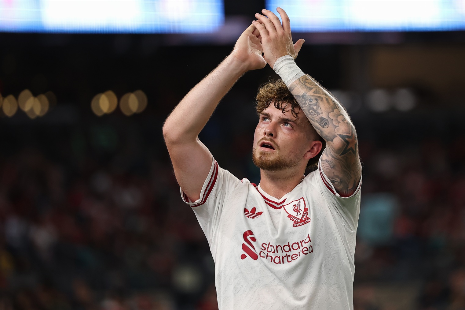 Harvey Elliott applauds to the crowd during a pre-season game for Liverpool