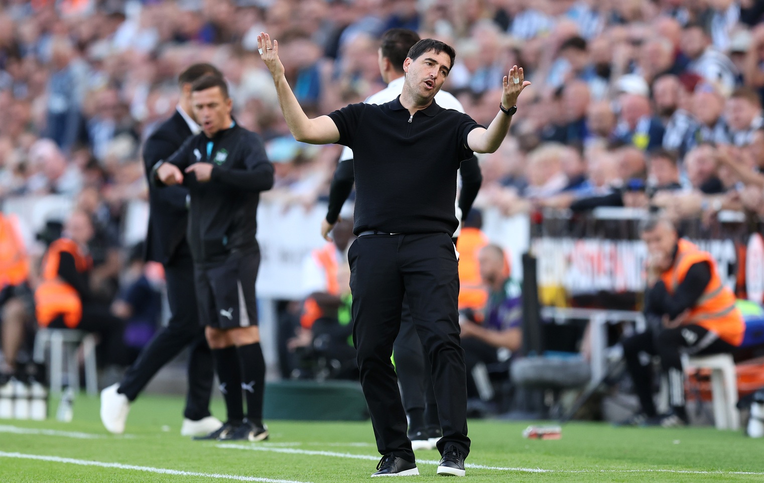 Andoni Iraola throws his arms into the air in frustration