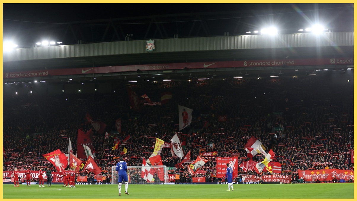 Liverpool fans in the Kop display flags and banners