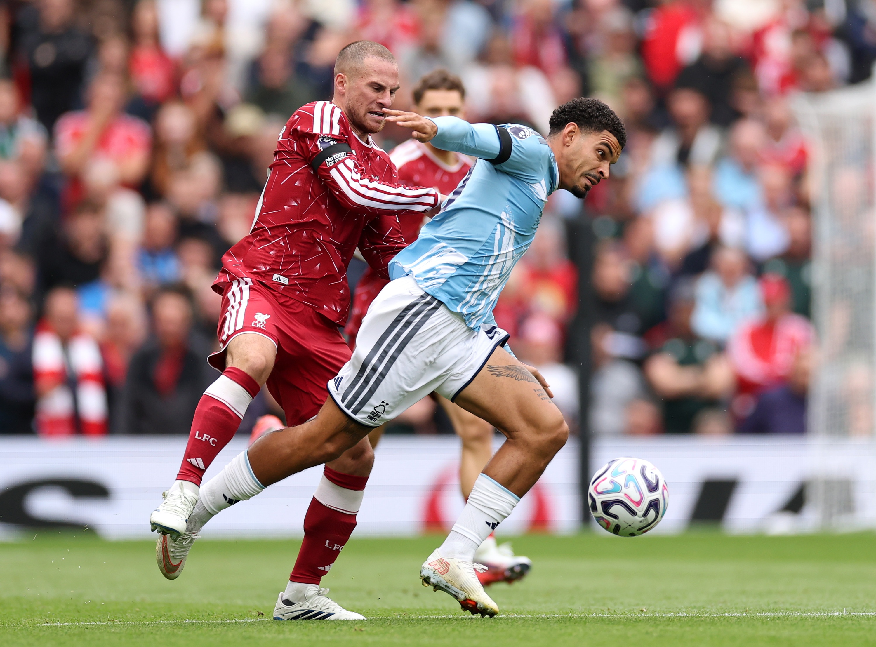 Alexis Mac Allister puts his hands on Morgan Gibbs-White's back during Liverpool vs Nottingham Forest.