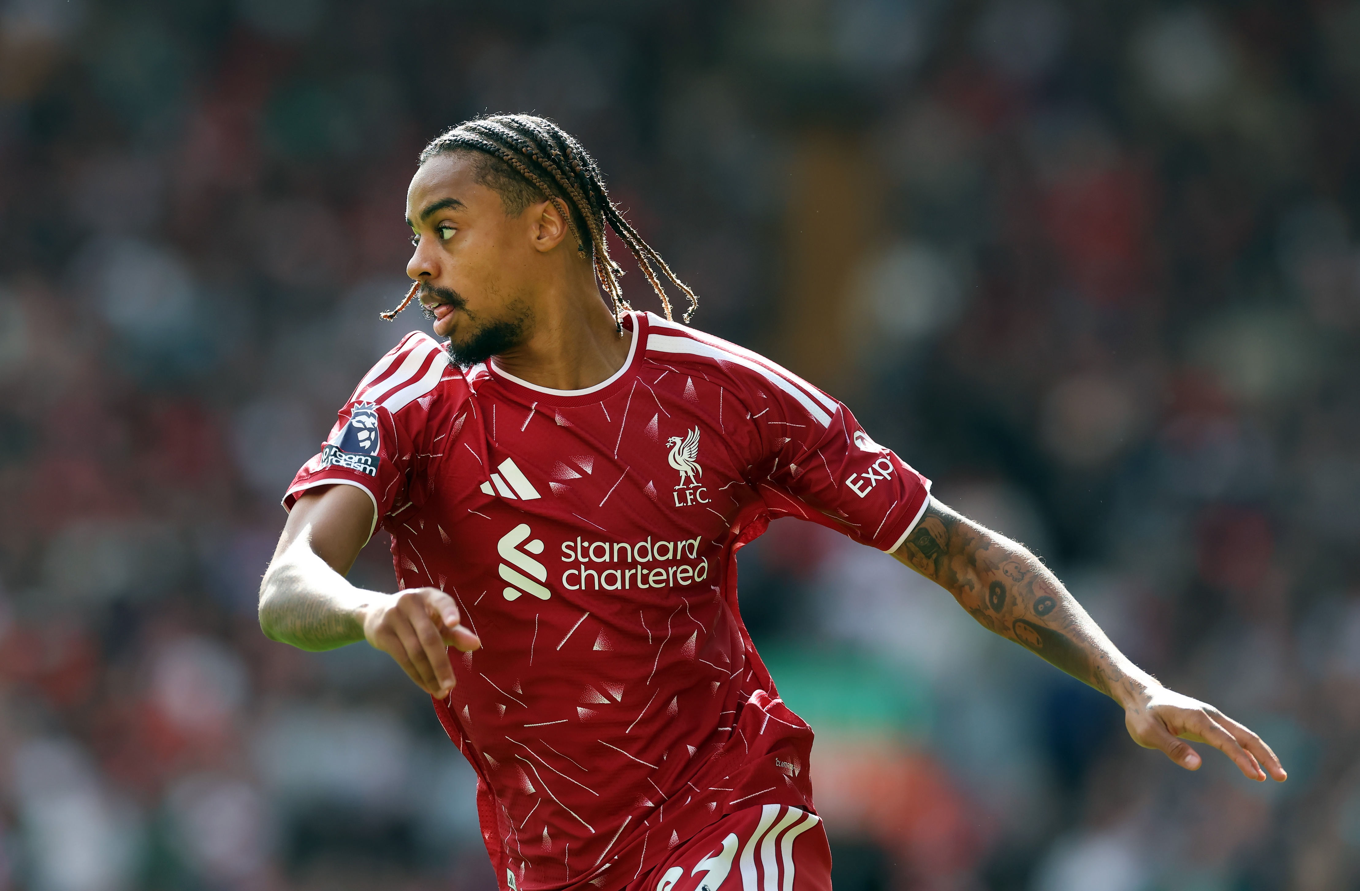 Liverpool winger Bradley Barcola twists his body and looks over his right shoulder.