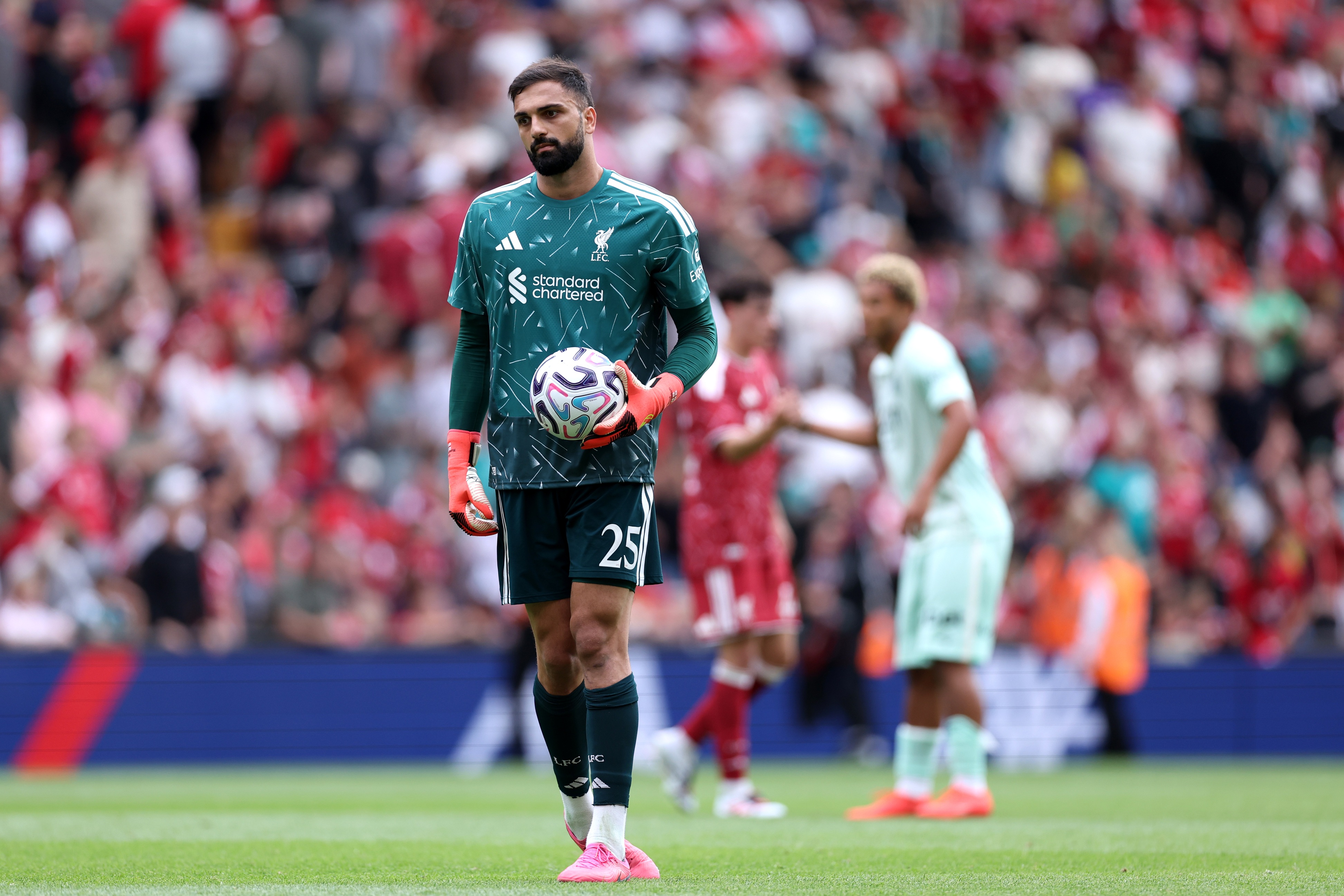 Liverpool goalkeeper Giorgi Mamardashvili holds the football in his left hand.