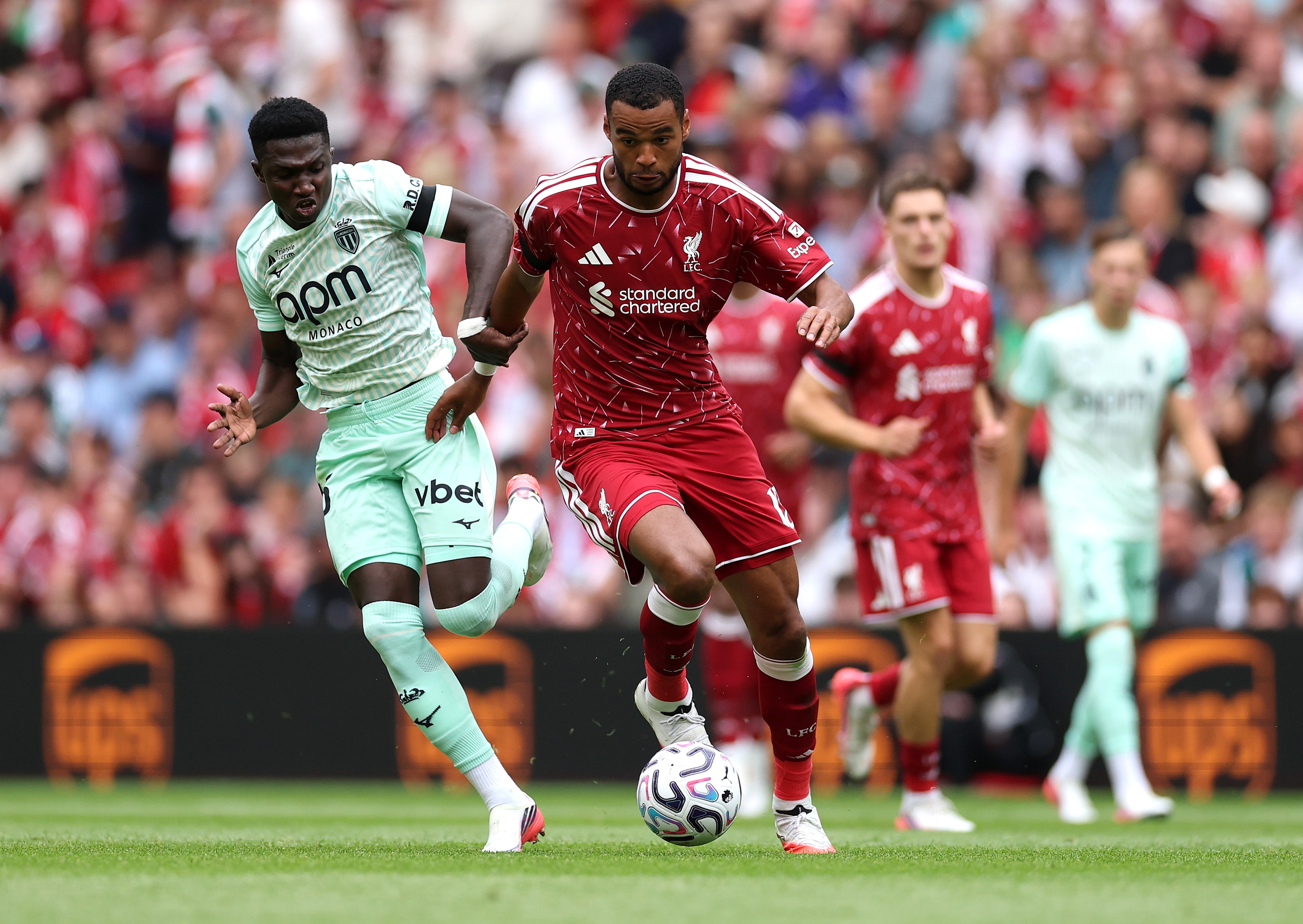 Monaco midfielder Lamine Camara chases after Liverpool winger Cody Gakpo.