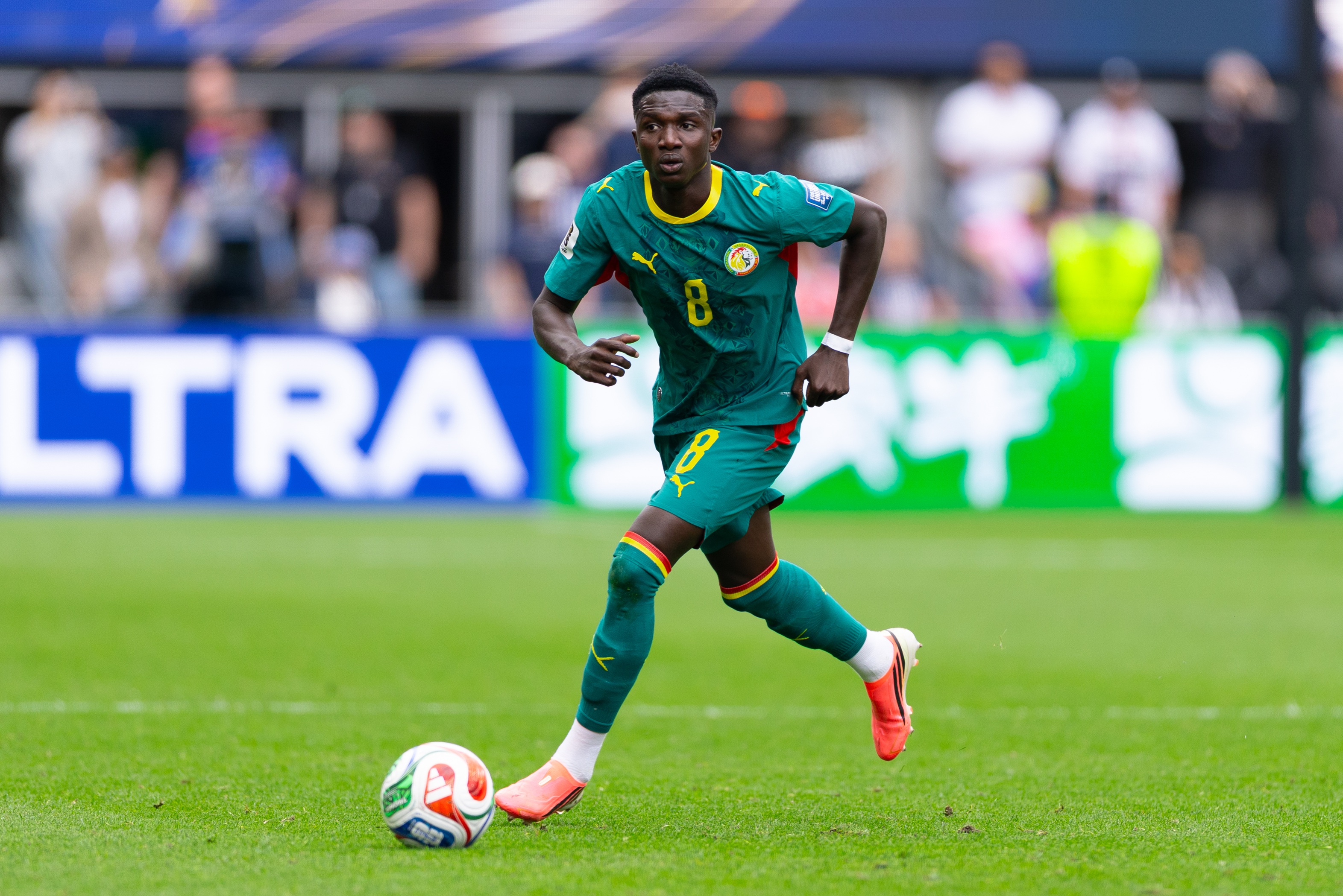New Chelsea signing Lamine Camara dribbles with the ball during Senegal game.