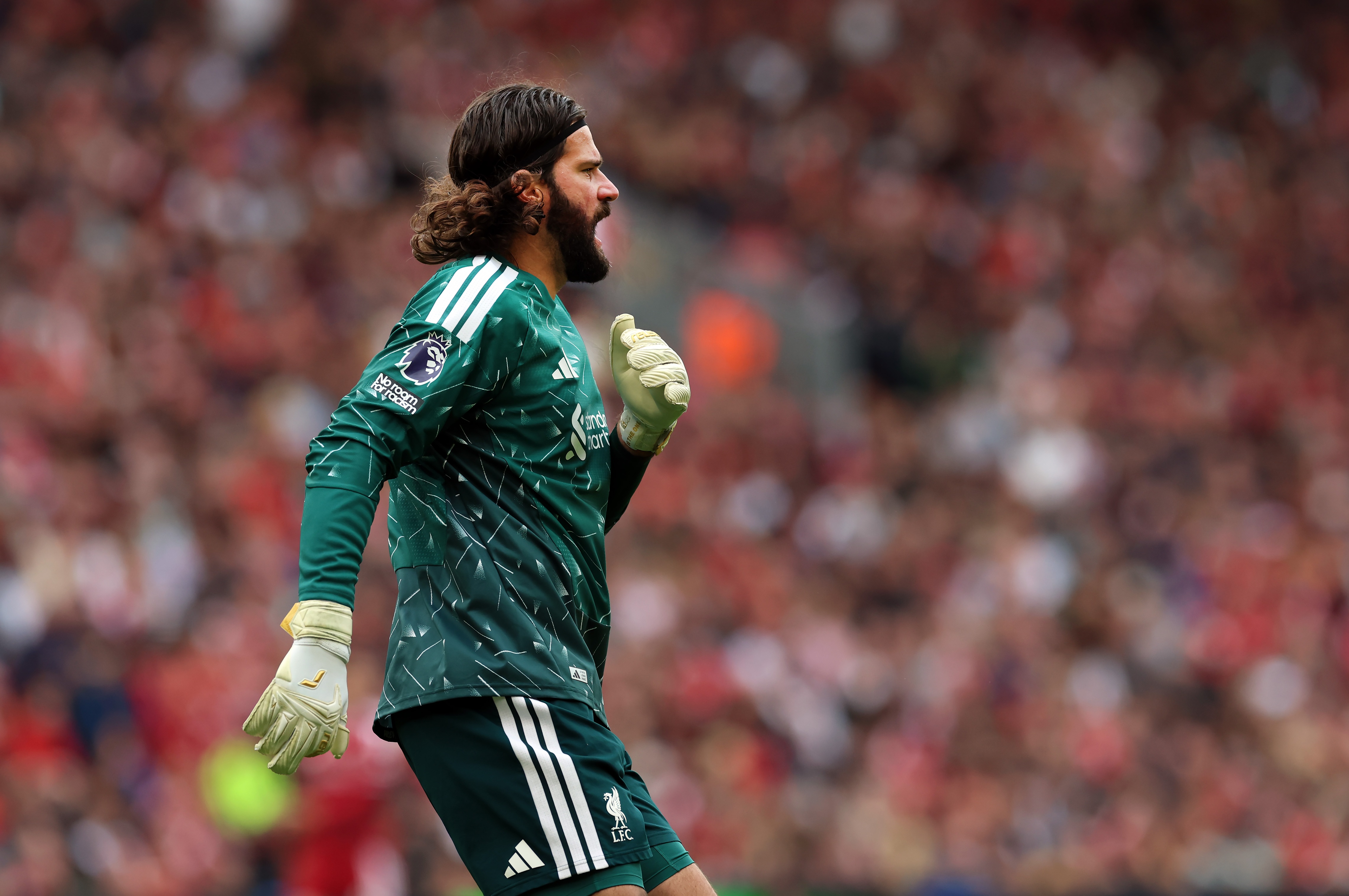 Liverpool goalkeeper Alisson Becker runs on the pitch.