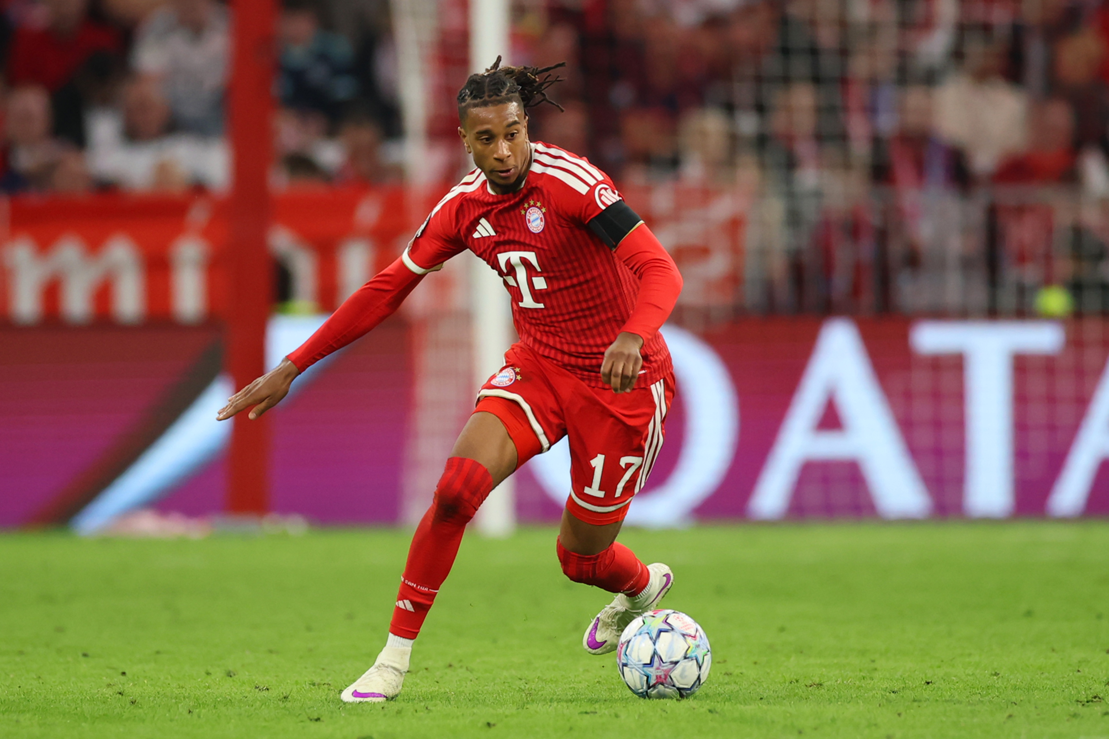 Michael Olise dribbles on the ball for Bayern Munich.