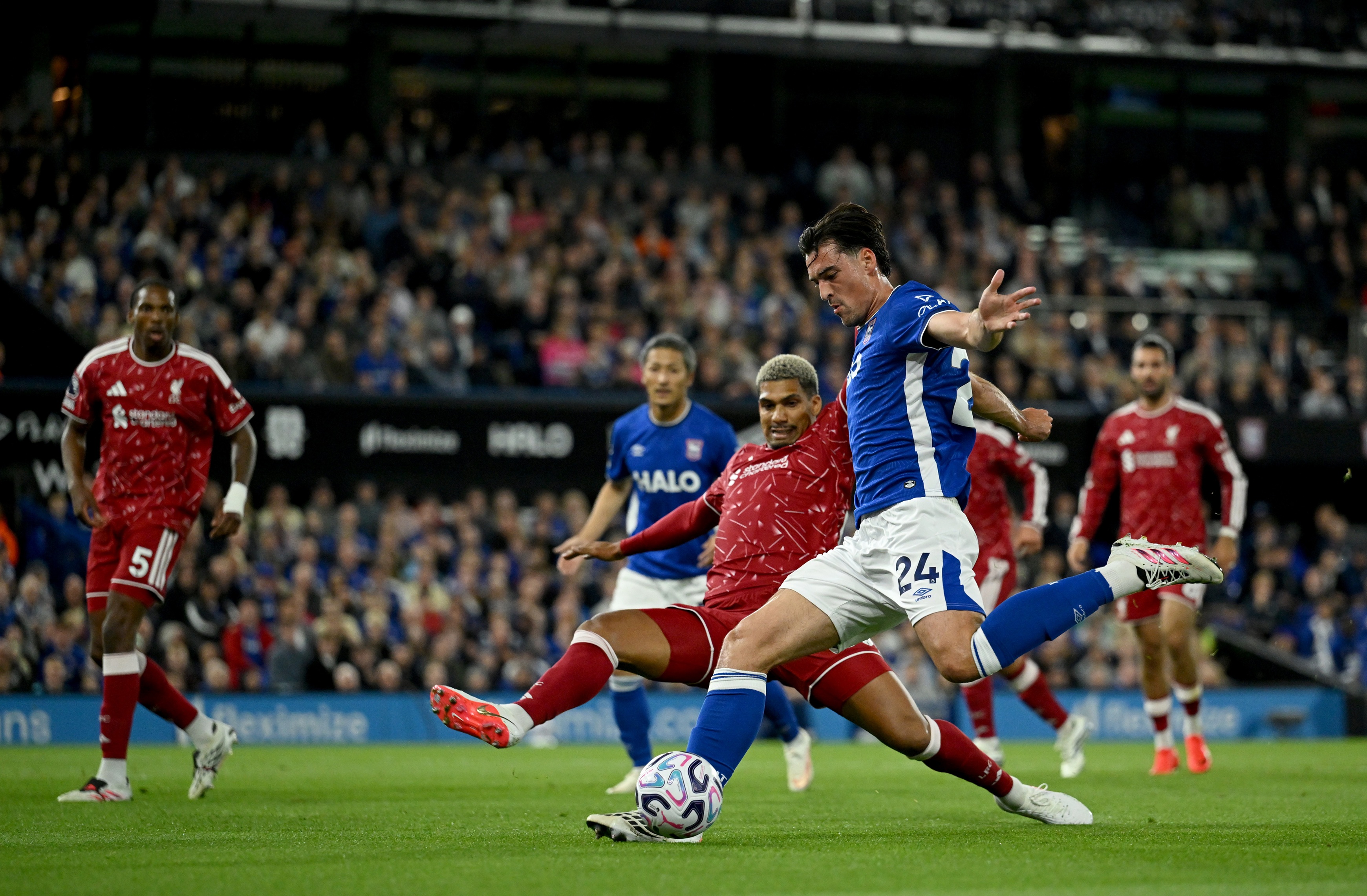 Liverpool centre-back Ronald Araujo lunges to tackle Jacob Greaves of Ipswich Town.