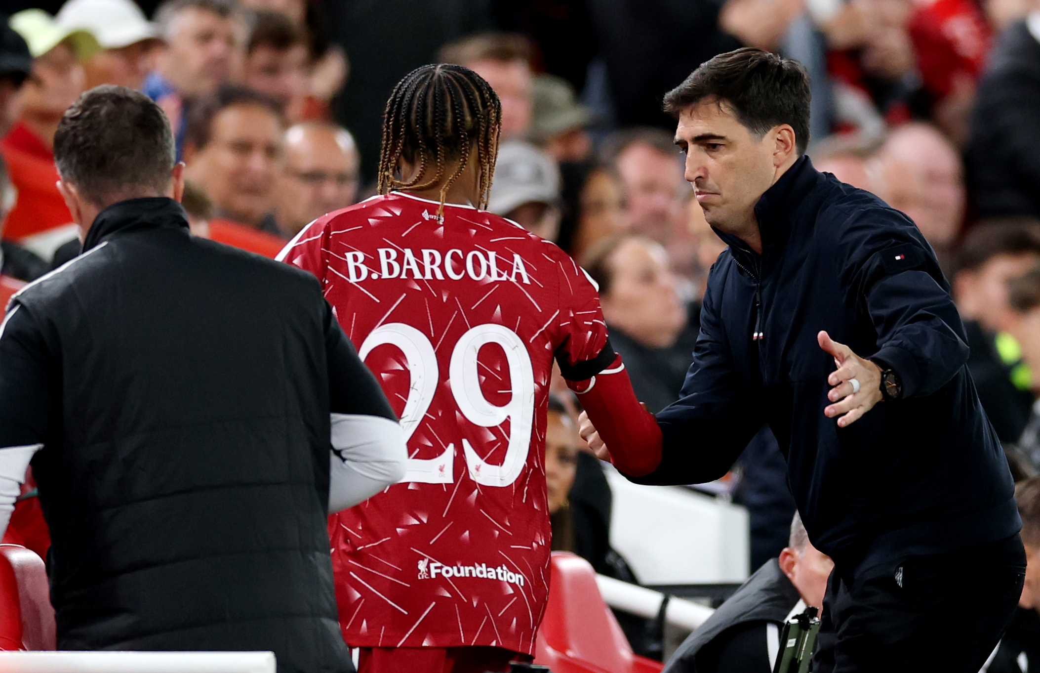 Andoni Iraola comiserates with Bradley Barcola after the winger is substituted against Atletico Madrid