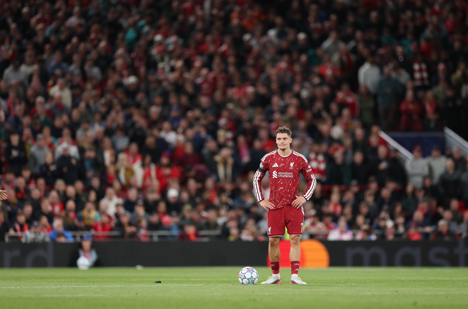 Florian Wirtz stands with his hands on his hips during a Liverpool match