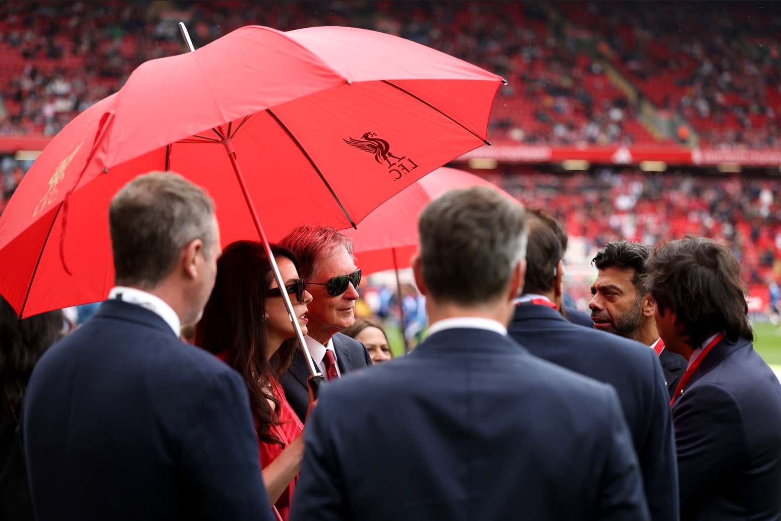 Liverpool owner John Henry speaks with vice-chairman Amit Bhatia at Anfield