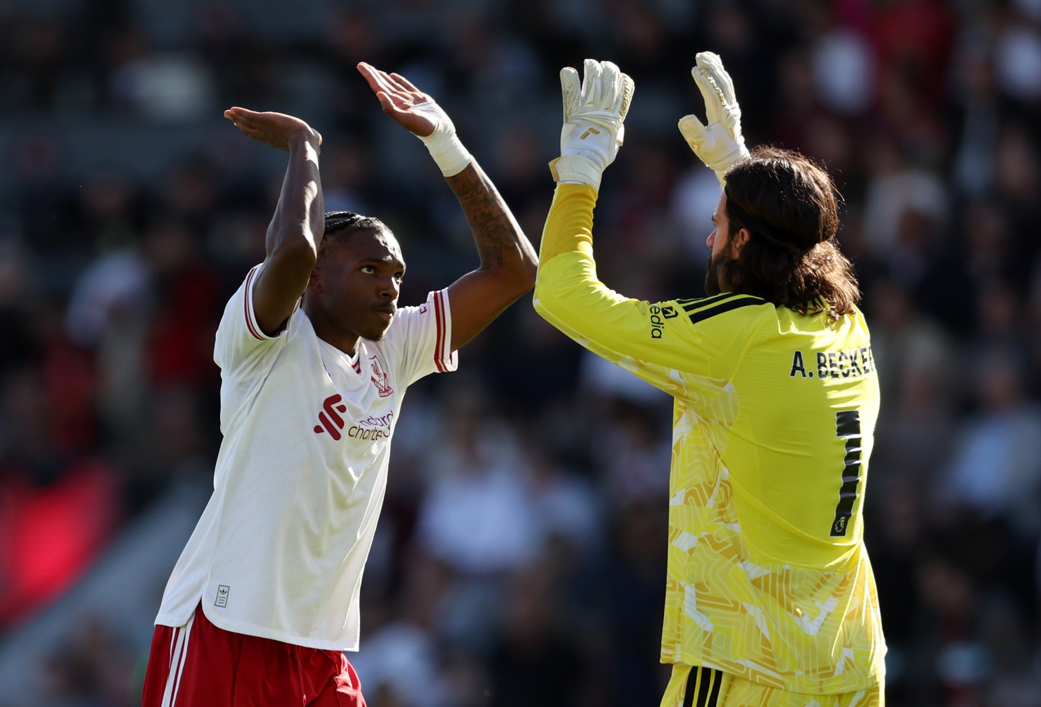 Jeremy Jacquet and Alisson Becker high-five during Liverpool's win at Bournemouth
