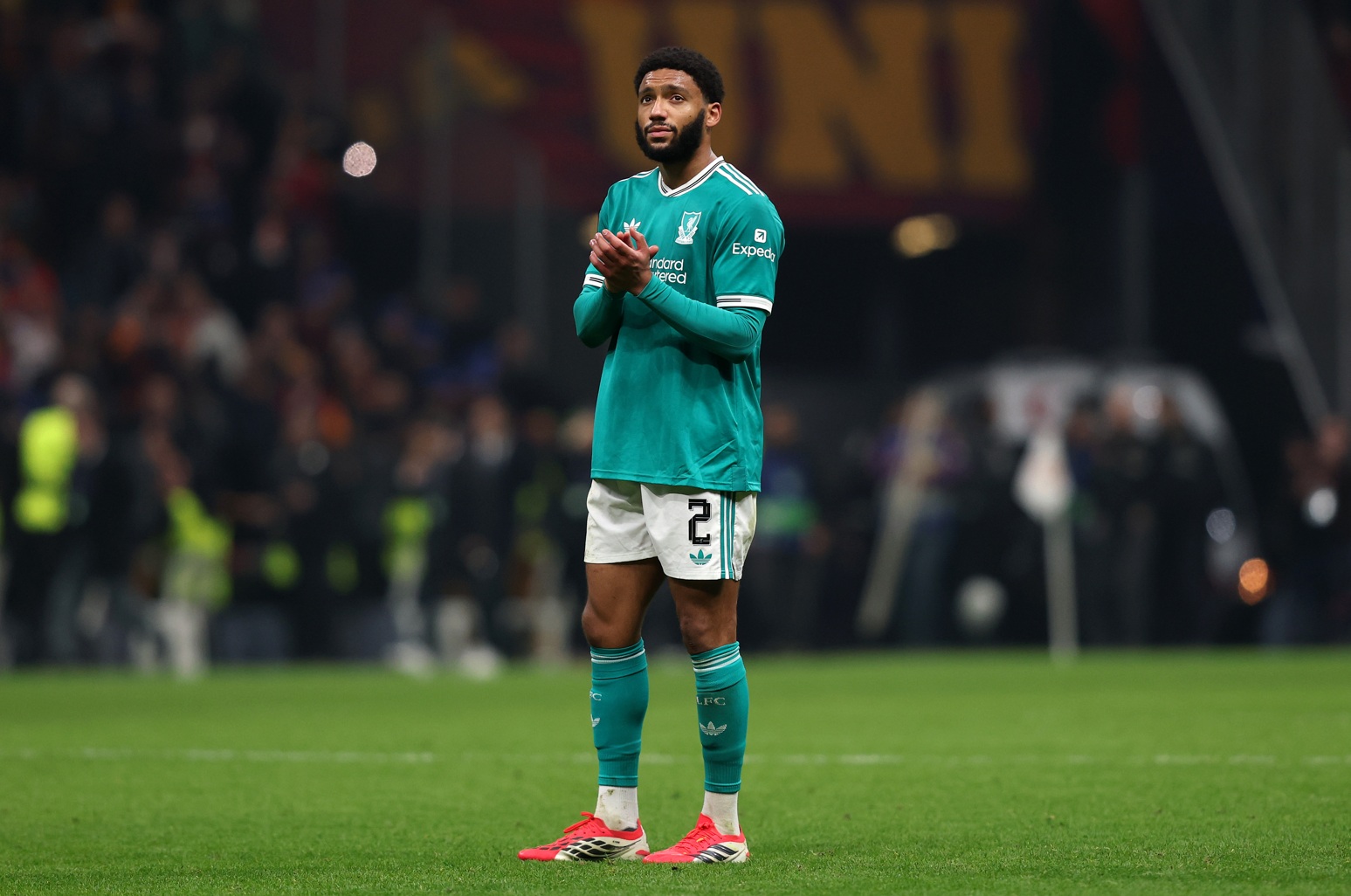 Joe Gomez applauds Liverpool fans after a Champions League match