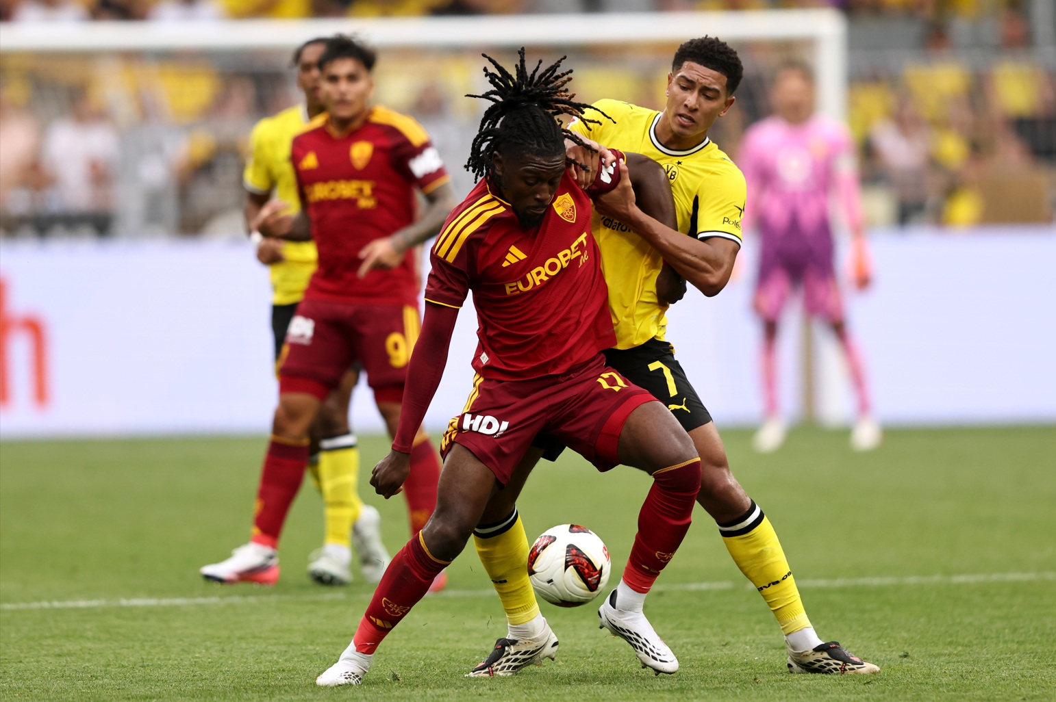 Roma midfielder Manu Kone holds off the challenge of Jobe Bellingham