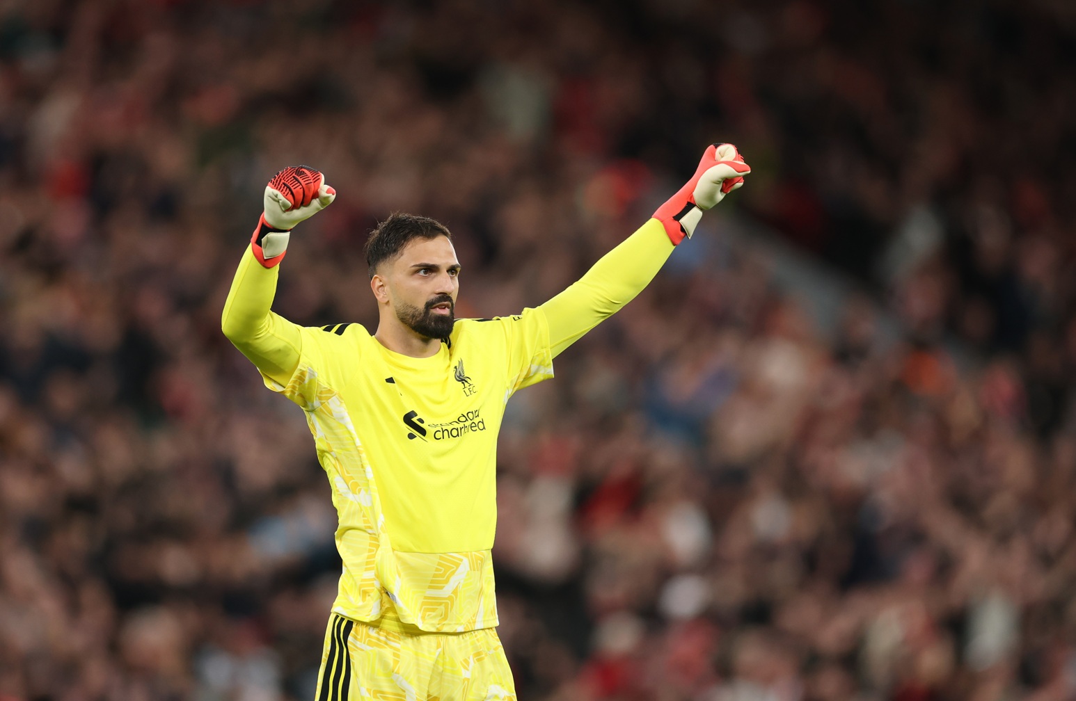 Giorgi Mamardashvili salutes the crowd during Liverpool's win over Spurs at Anfield