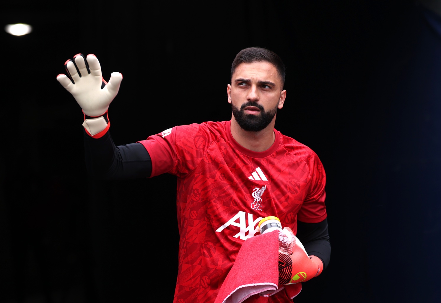 Giorgi Mamardashvili waves to Liverpool fans before a pre-season fixture