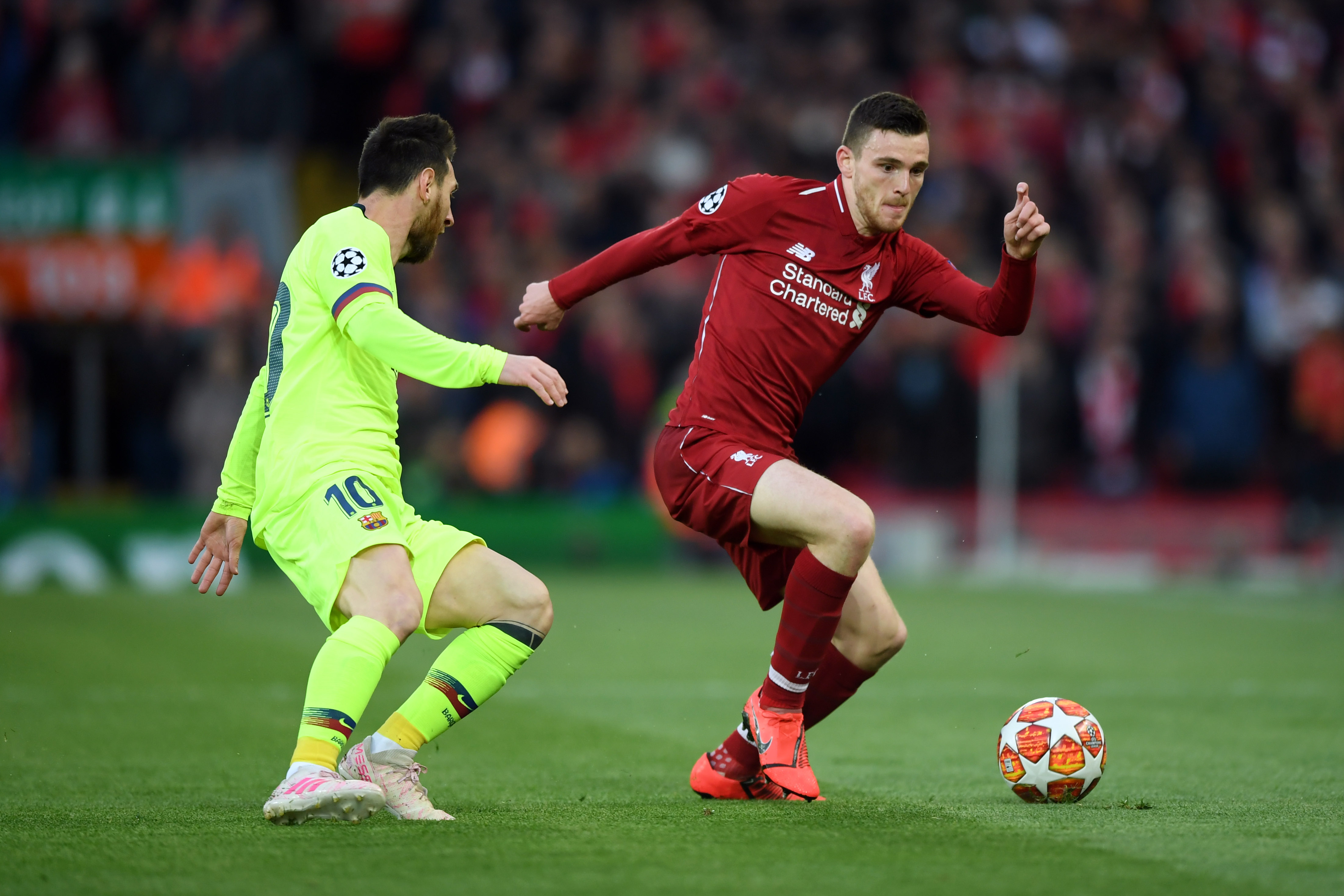 Andy Robertson gets away from Lionel Messi at Anfield in 2019