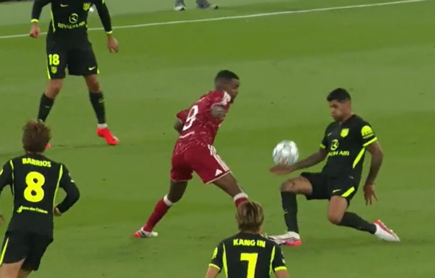 Cristian Romero catches Alexander Isak with a late challenge at Anfield