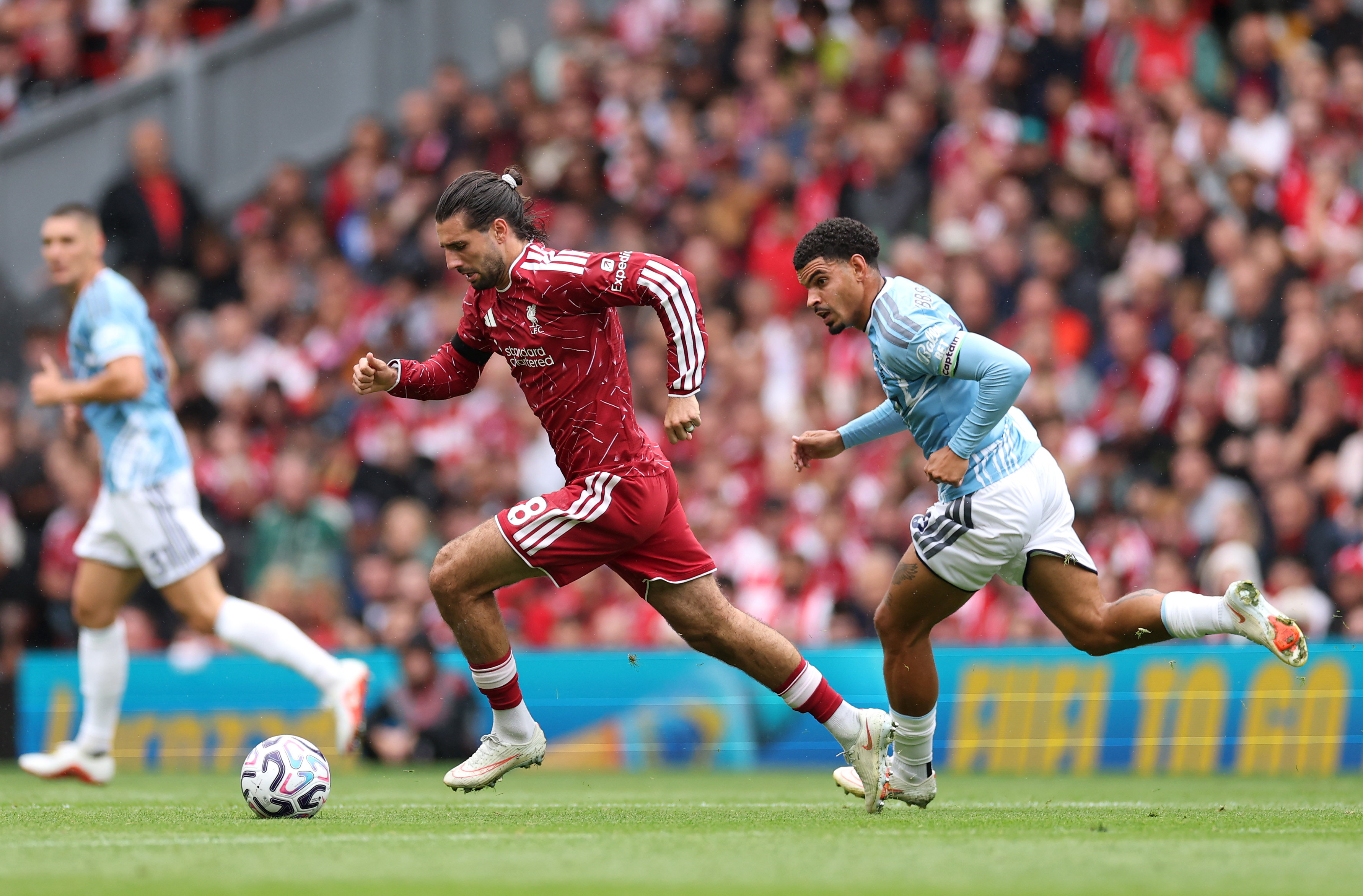 Dominik Szoboszlai seeks to escape the attention of Morgan Gibbs-White