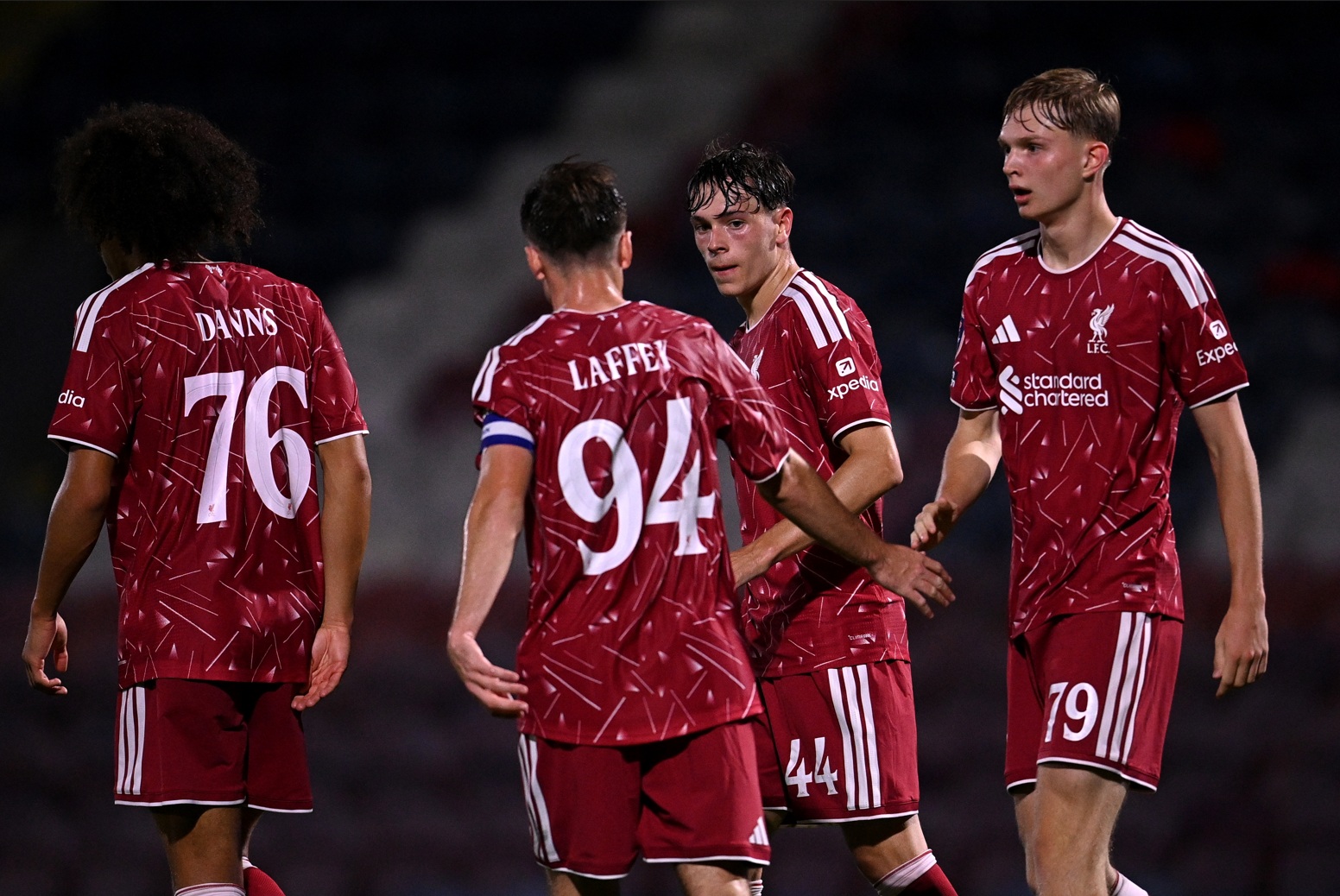 Will Wright is congratulated by his Liverpool under-21 teammates after scoring against Rochdale
